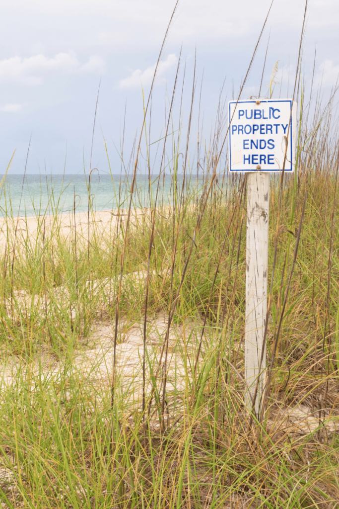 Clear boundaries. Sign on a beach that says public property ends here
